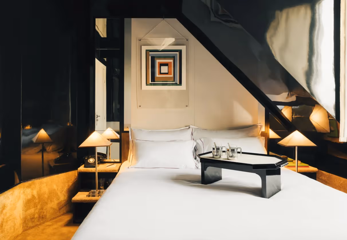 Loft suite with a graphic design aesthetic and a bed tray, 4-star Hôtel Château d’Eau, Paris 10th arrondissement.