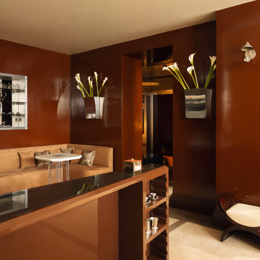 Elegant lounge with sofa and vases of flowers, four-star design hotel Château d’Eau, Paris.