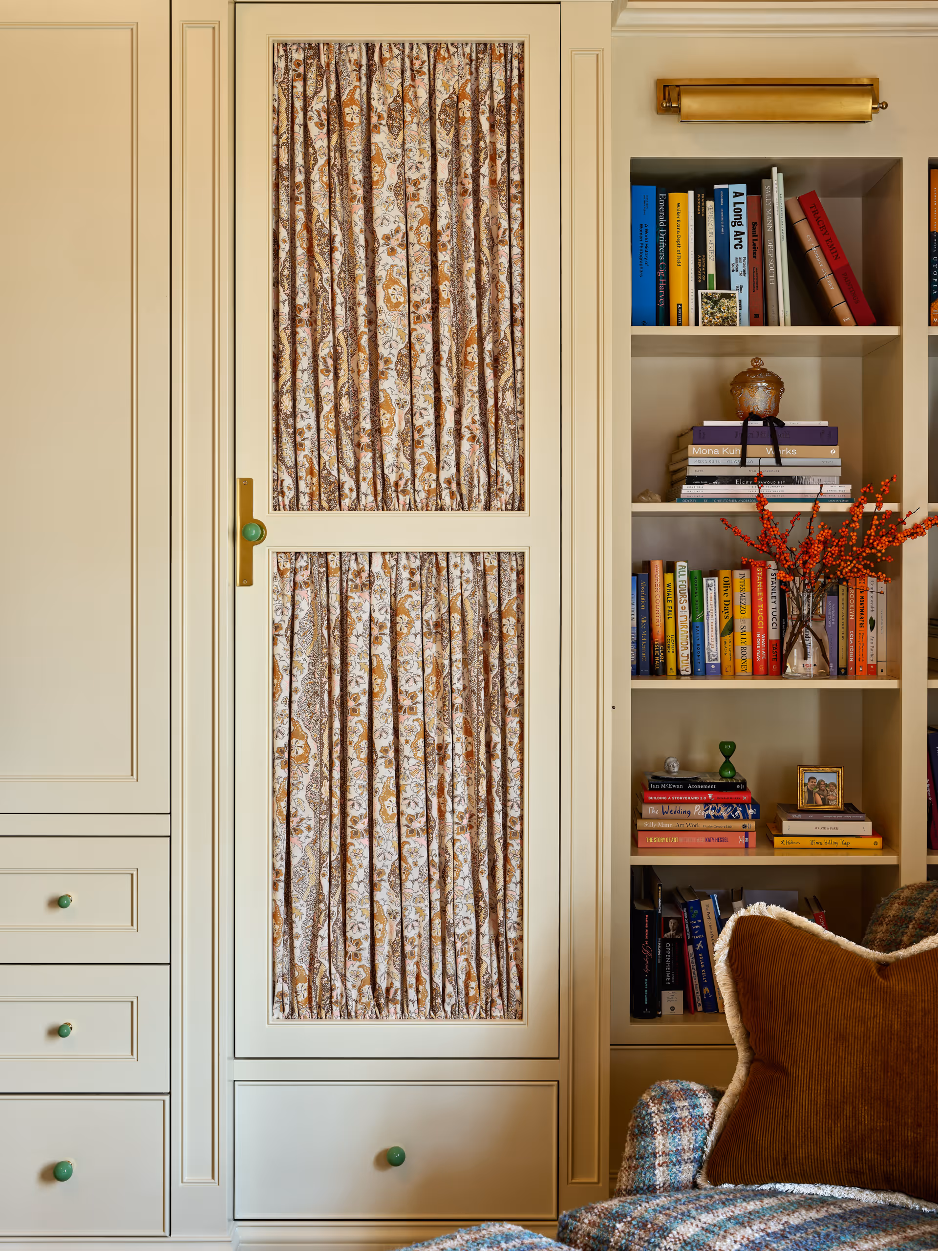 Cream-colored built-in cabinet with bookshelf
