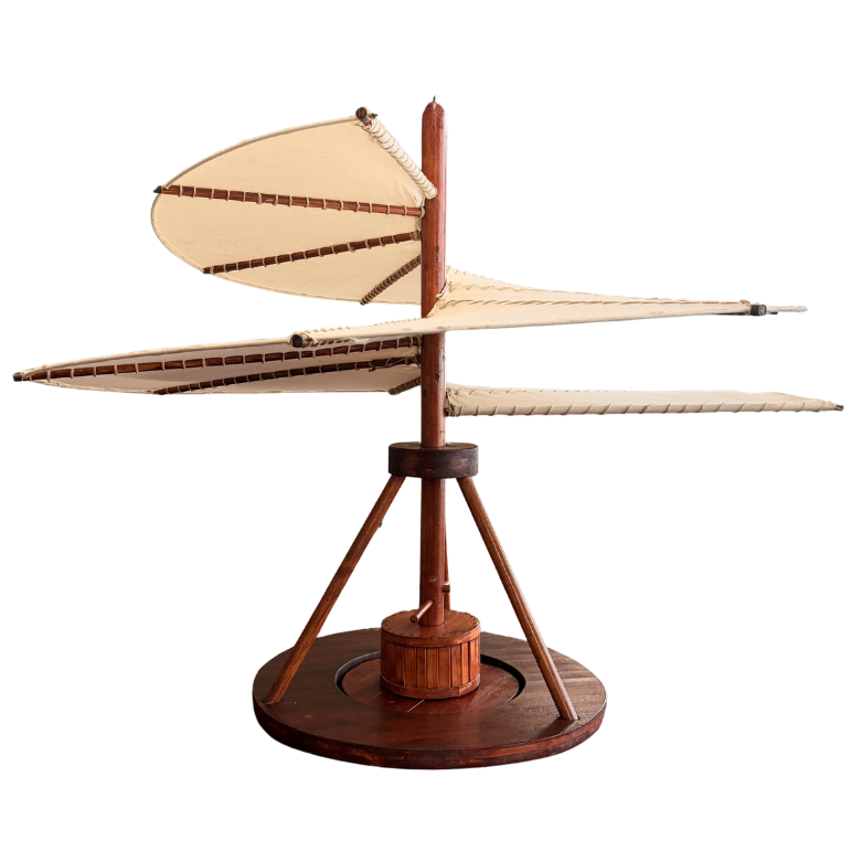 Wooden model of Leonardo da Vinci’s ornithopter with fabric wings on a round base.