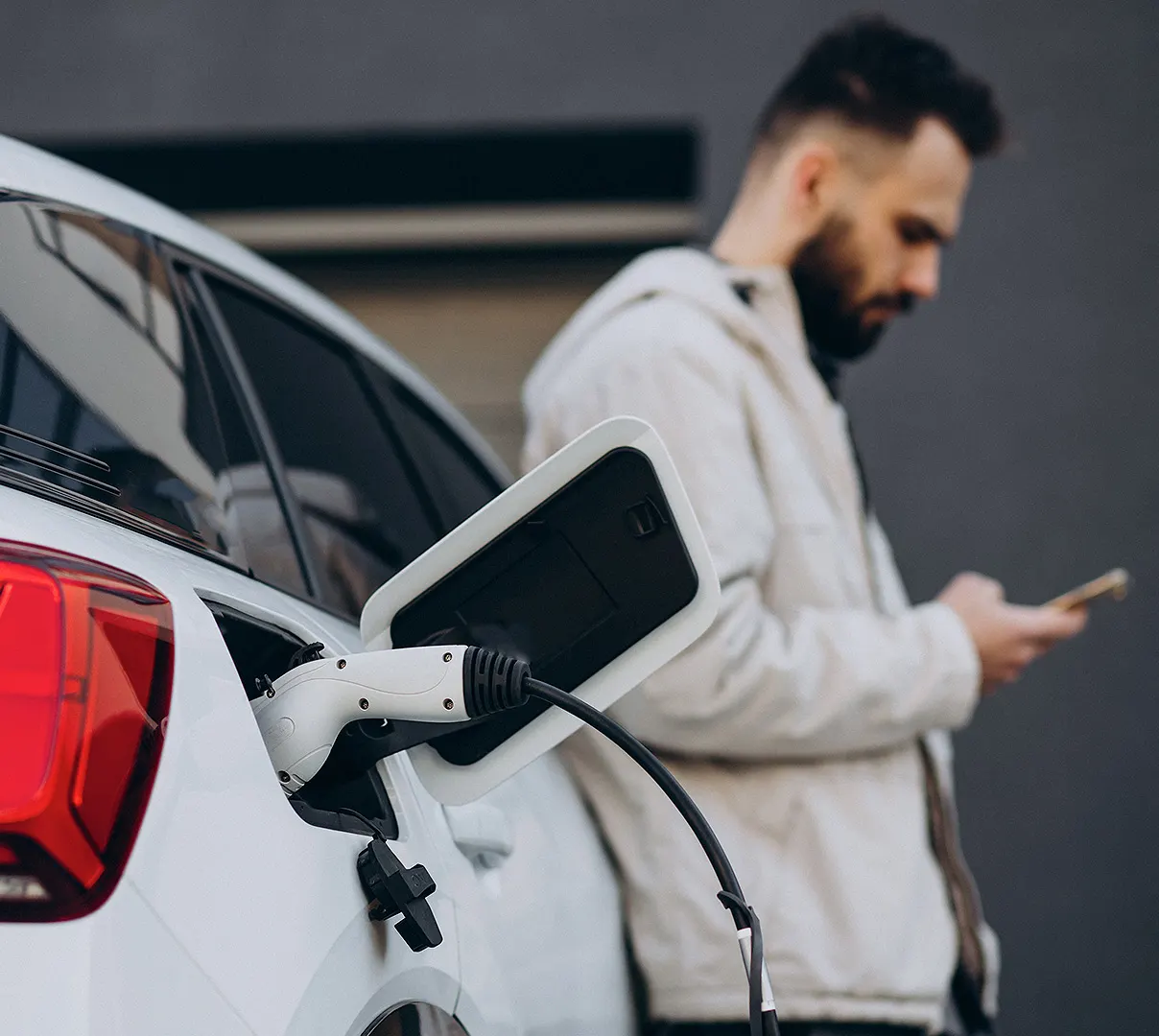 Driver charging an electric car