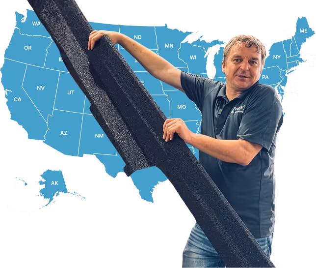 Man holding a large black foam piece standing in front of a blue US map showing state abbreviations.