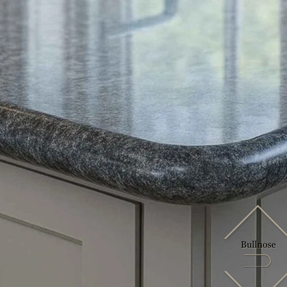 Close-up of a dark granite kitchen countertop with a smooth rounded bullnose edge.