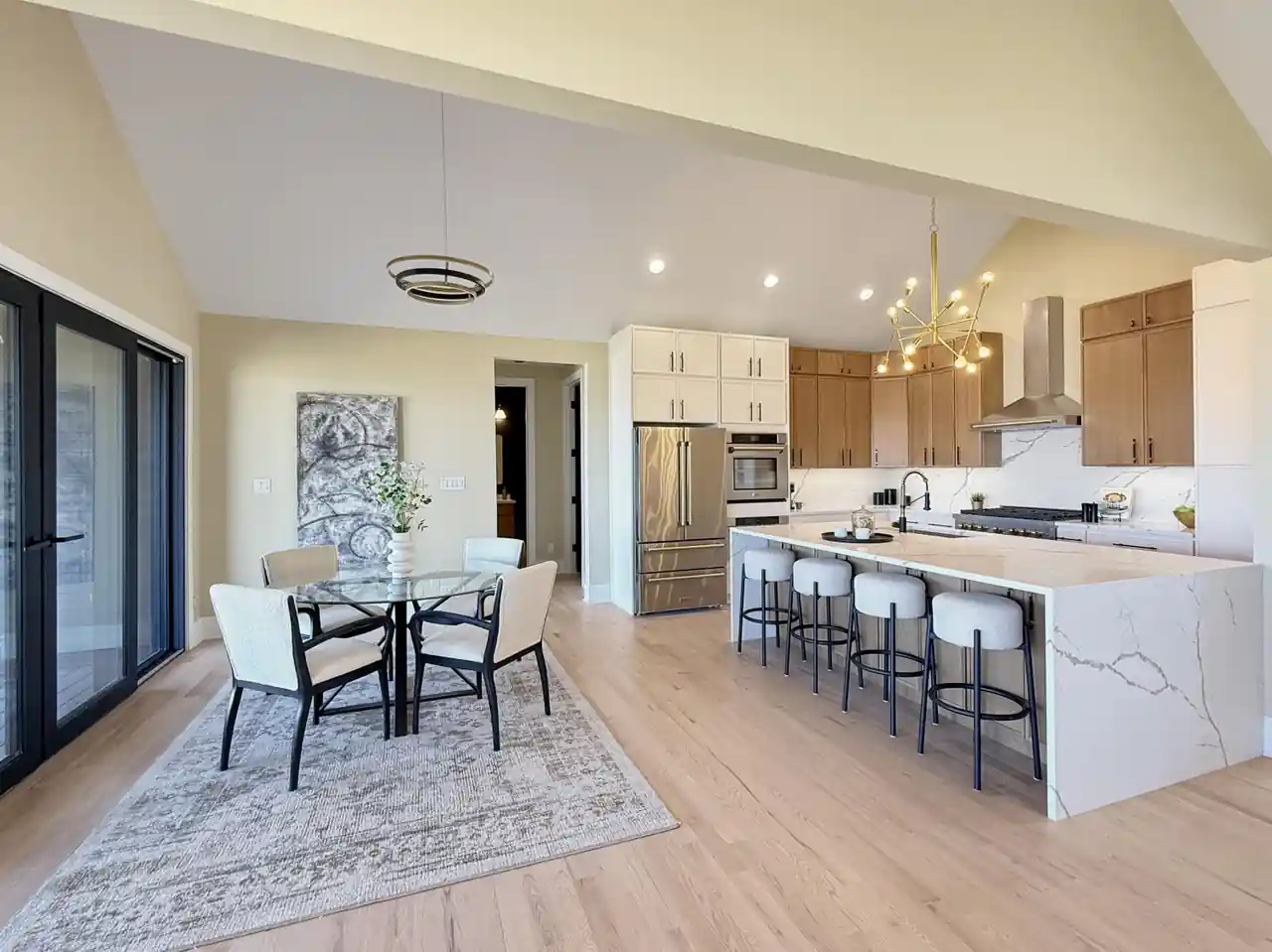 Eat-in kitchen with a round glass dining table set beside sliding doors to the deck.