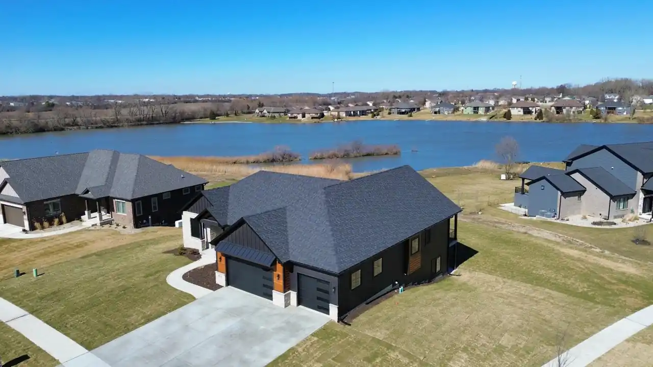 Aerial view of the Lakeview New Construction property nestled along the water's edge.
