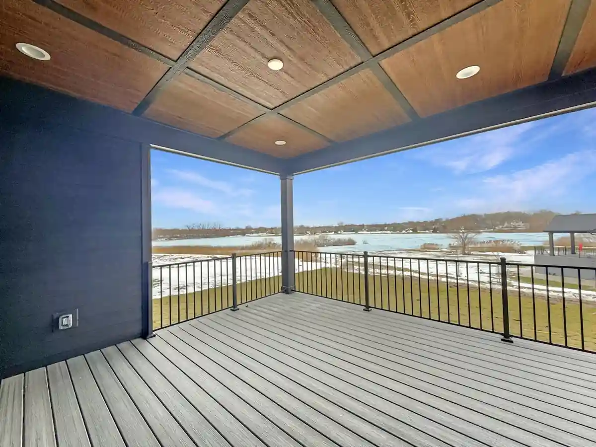 Covered upper deck with a wood-plank ceiling framing views of the frozen lake.