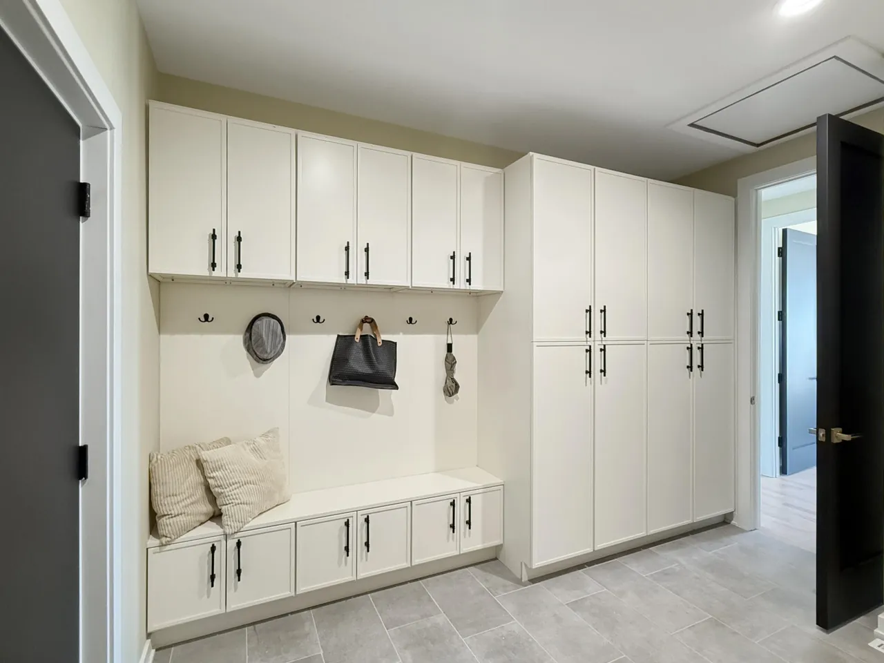 Mudroom with built-in cubbies, a cushioned bench seat, and floor-to-ceiling storage.