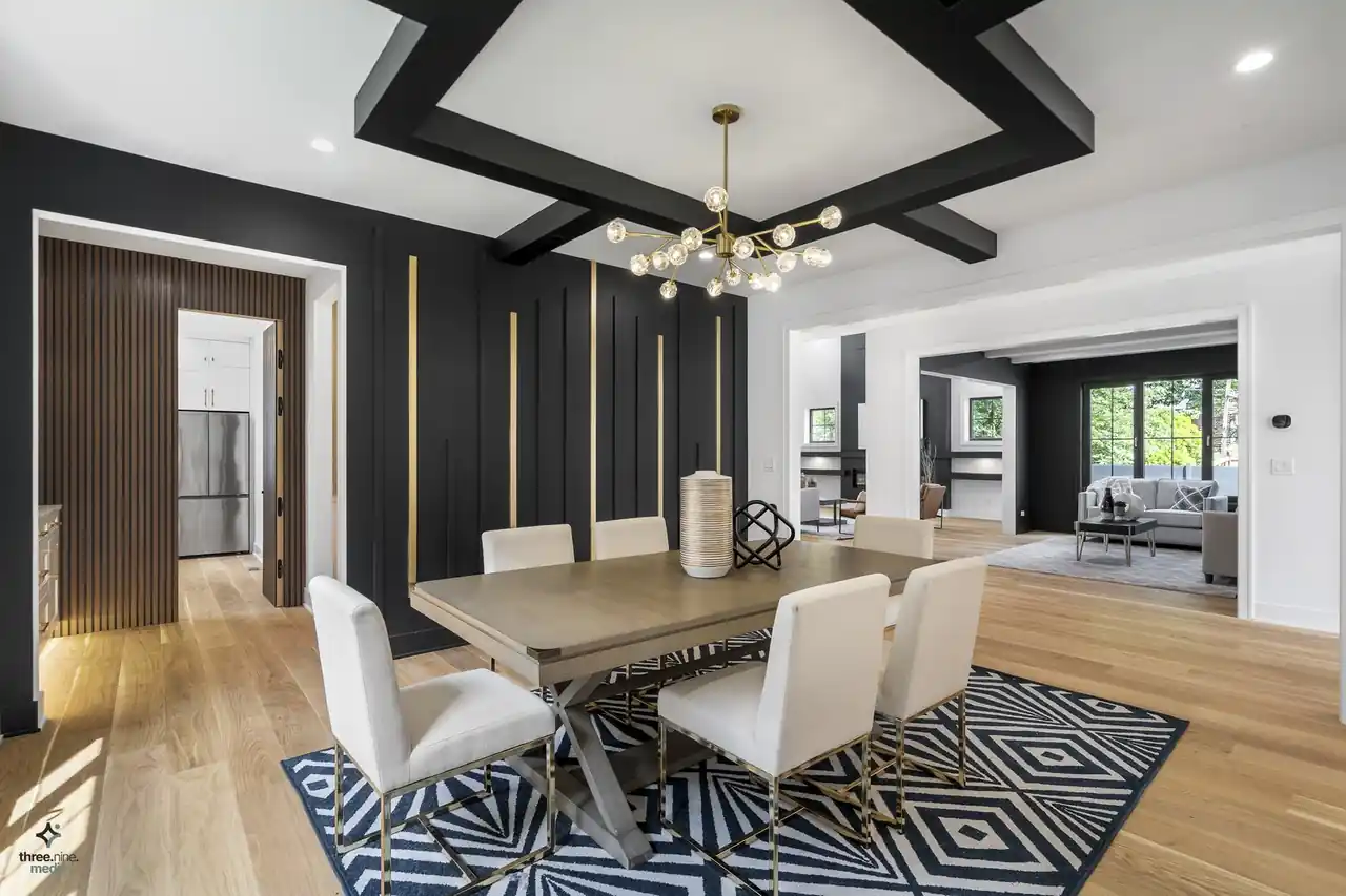 Dining room with a black board-and-batten accent wall and a brass-strip chandelier