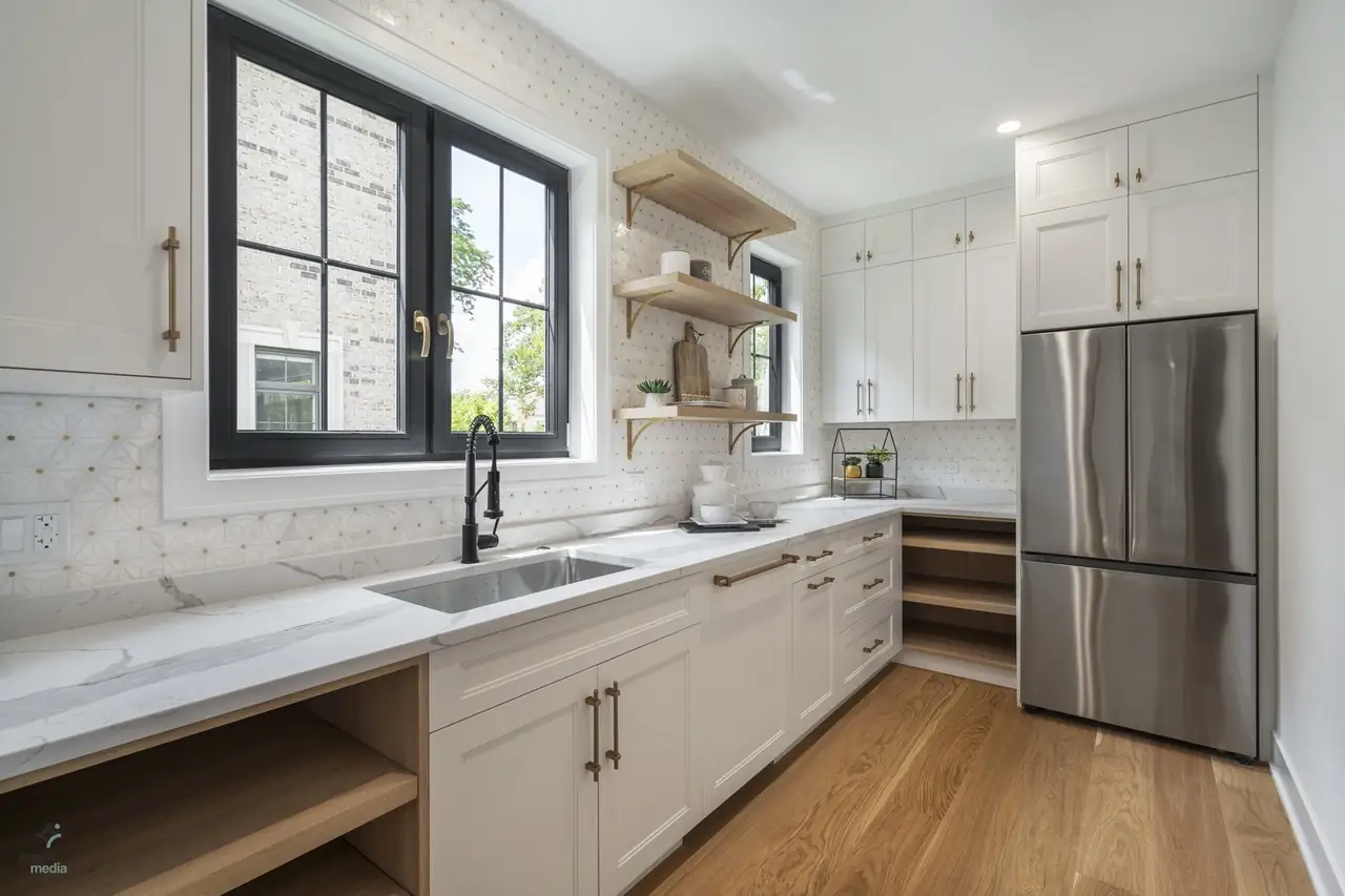 Kitchen prep area with white shaker cabinets, open shelving, and a walk-in pantry