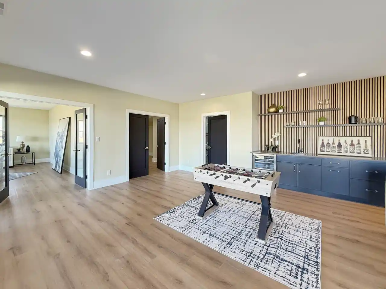 Basement wet bar with a wood-slat accent wall, open shelving, and a built-in beverage fridge.