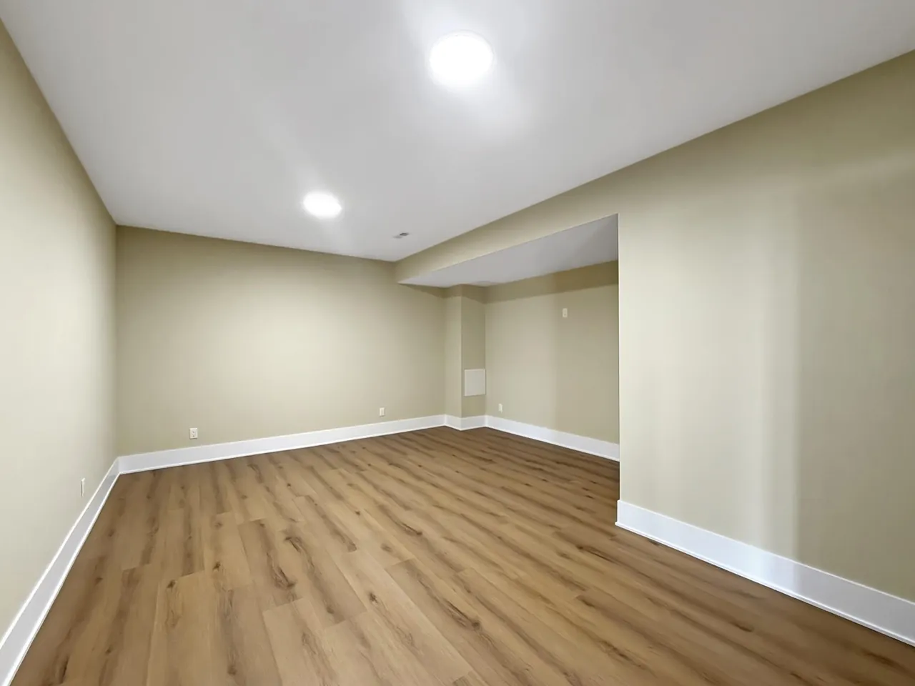 Unfurnished flex space with wide-plank flooring, ready to finish as an office or den.
