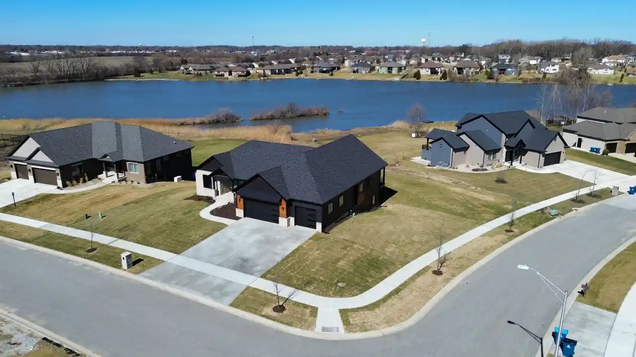 Aerial view with a map pin marking the home's exact site within the waterfront neighborhood.