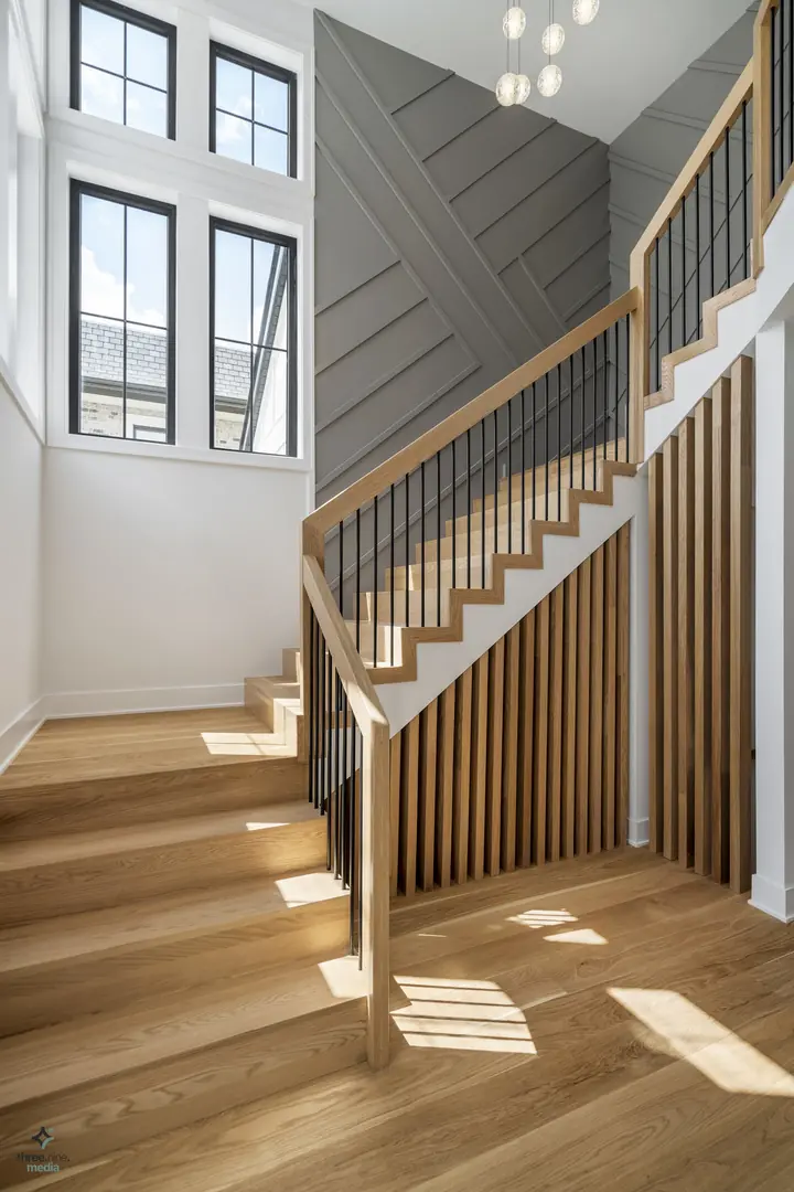 Staircase landing beneath a diagonal gray shiplap accent wall