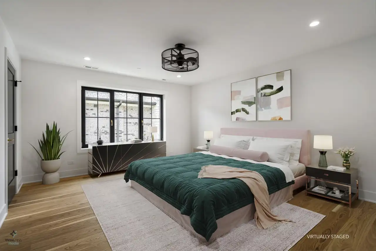 Virtually staged bedroom in sage green tones with a curved dresser