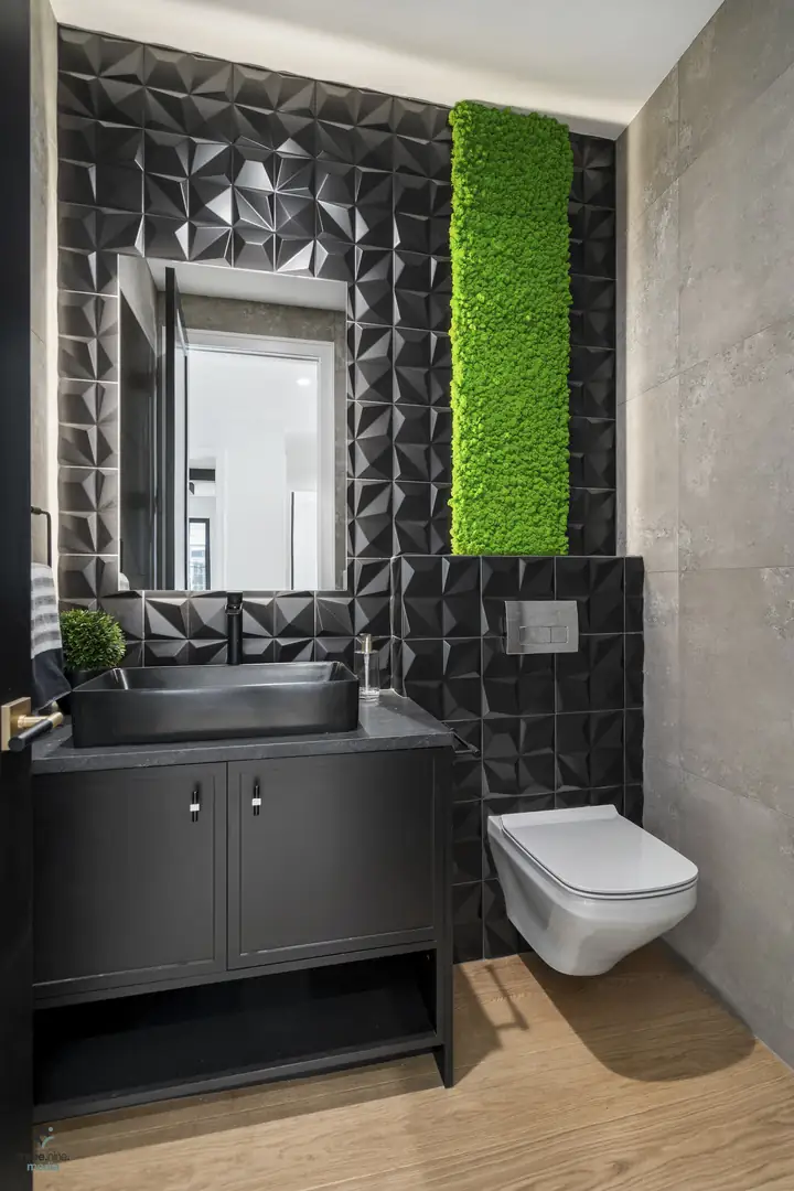 Powder room with sculptural black 3D tile and a live moss accent wall
