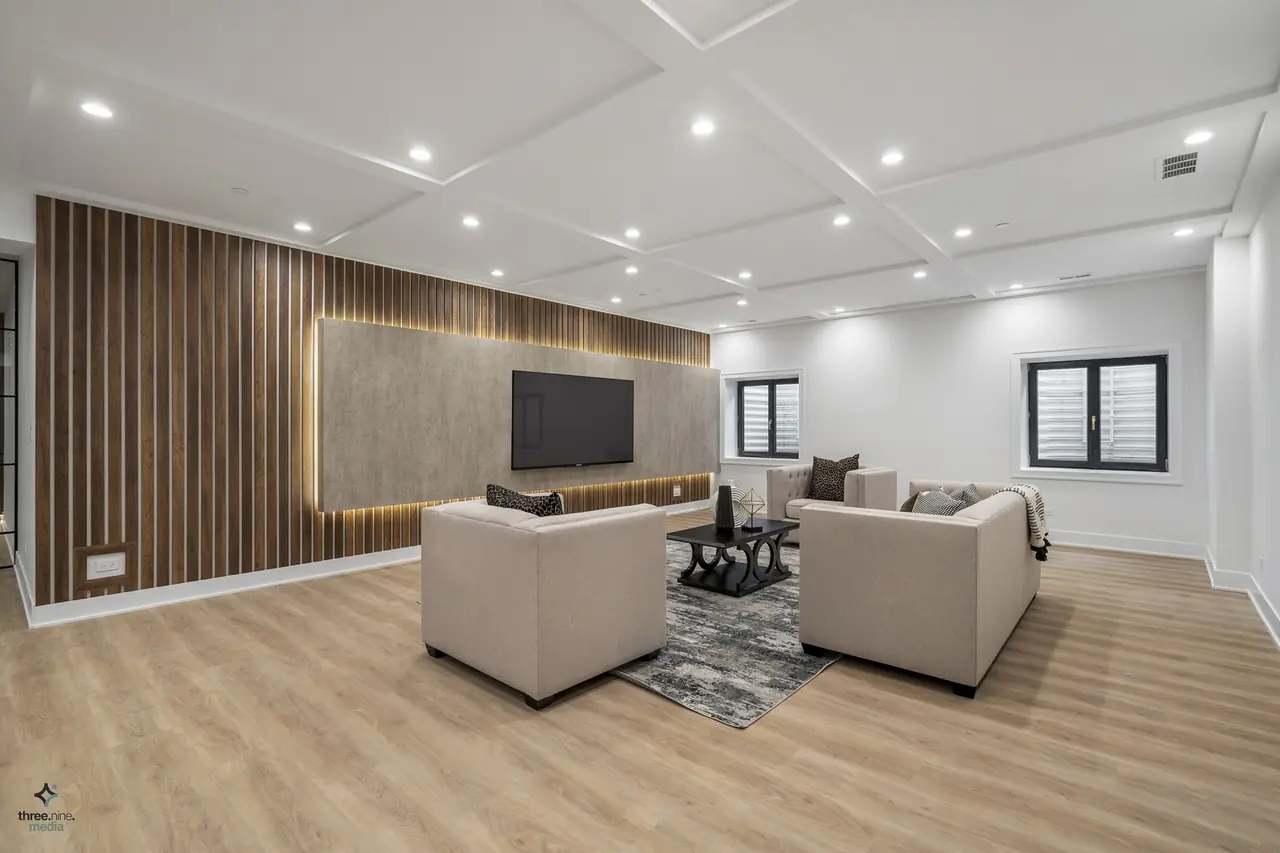 Basement rec room with a wood slat media wall and built-in TV, Northbrook, IL