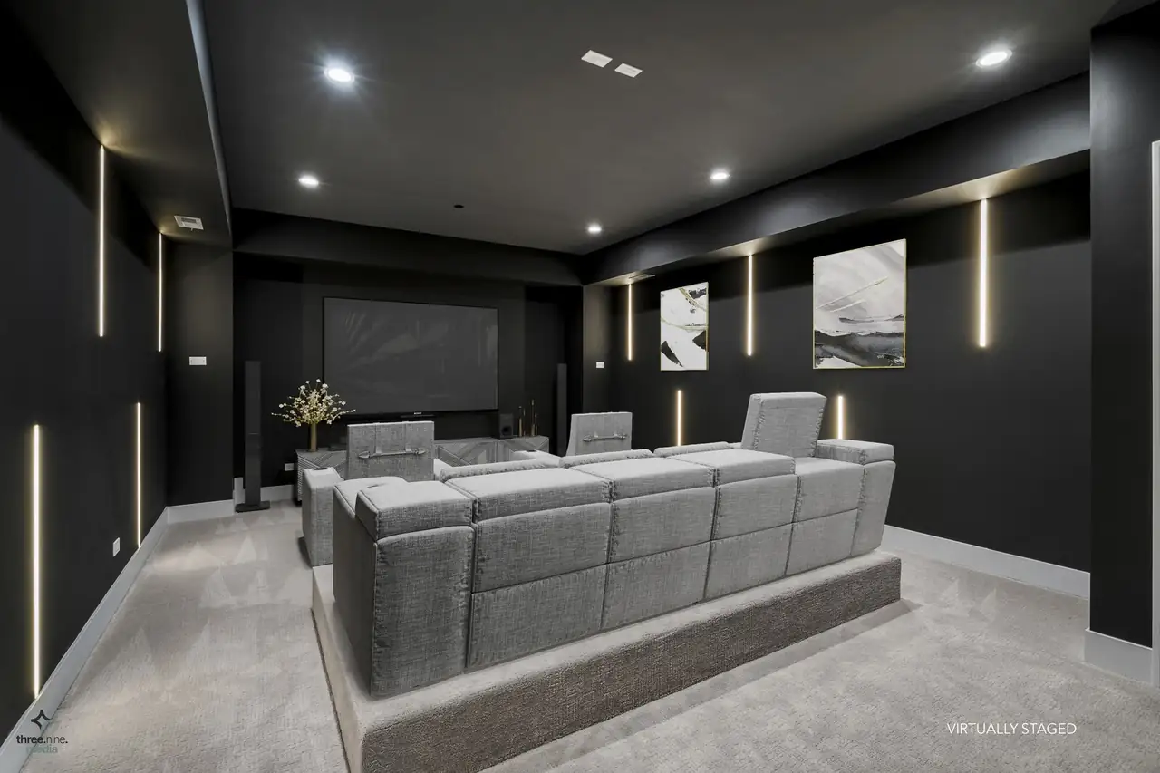 Virtually staged home theater with tiered seating and LED wall accents