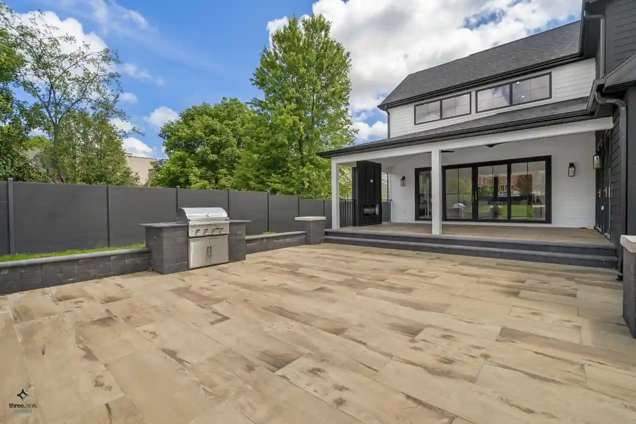 Backyard patio with a built-in grill station and covered porch, Alice New Construction, Northbrook, IL