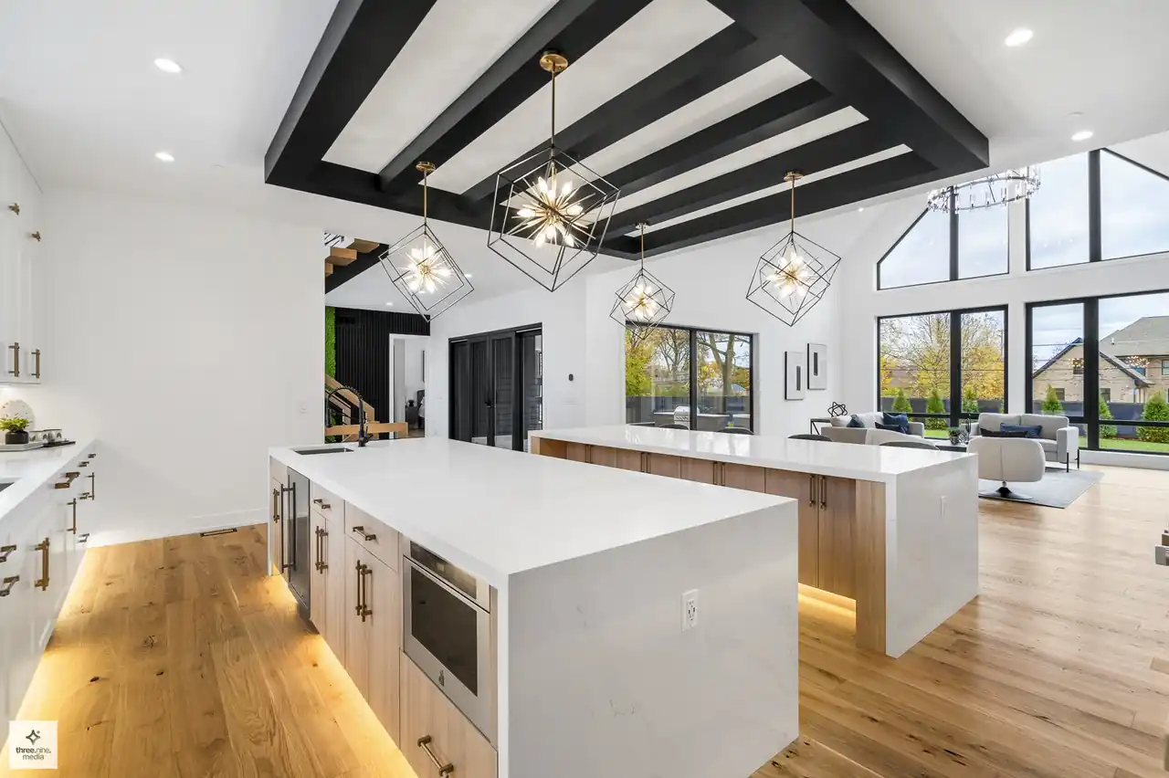 Kitchen sightline into the dining nook and vaulted living area with a peaked window wall
