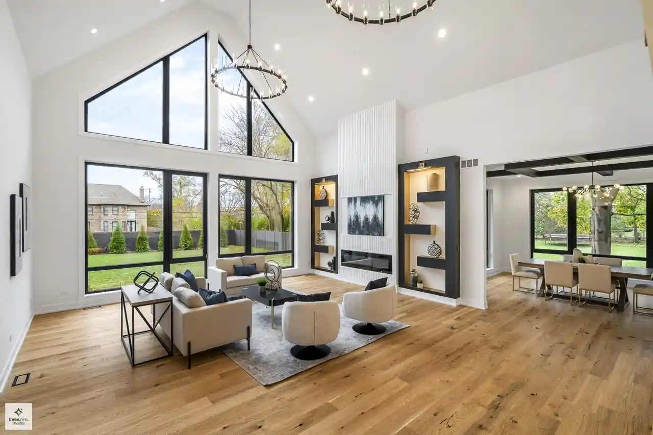 Vaulted living area opening into the kitchen, framed by a soaring gable window