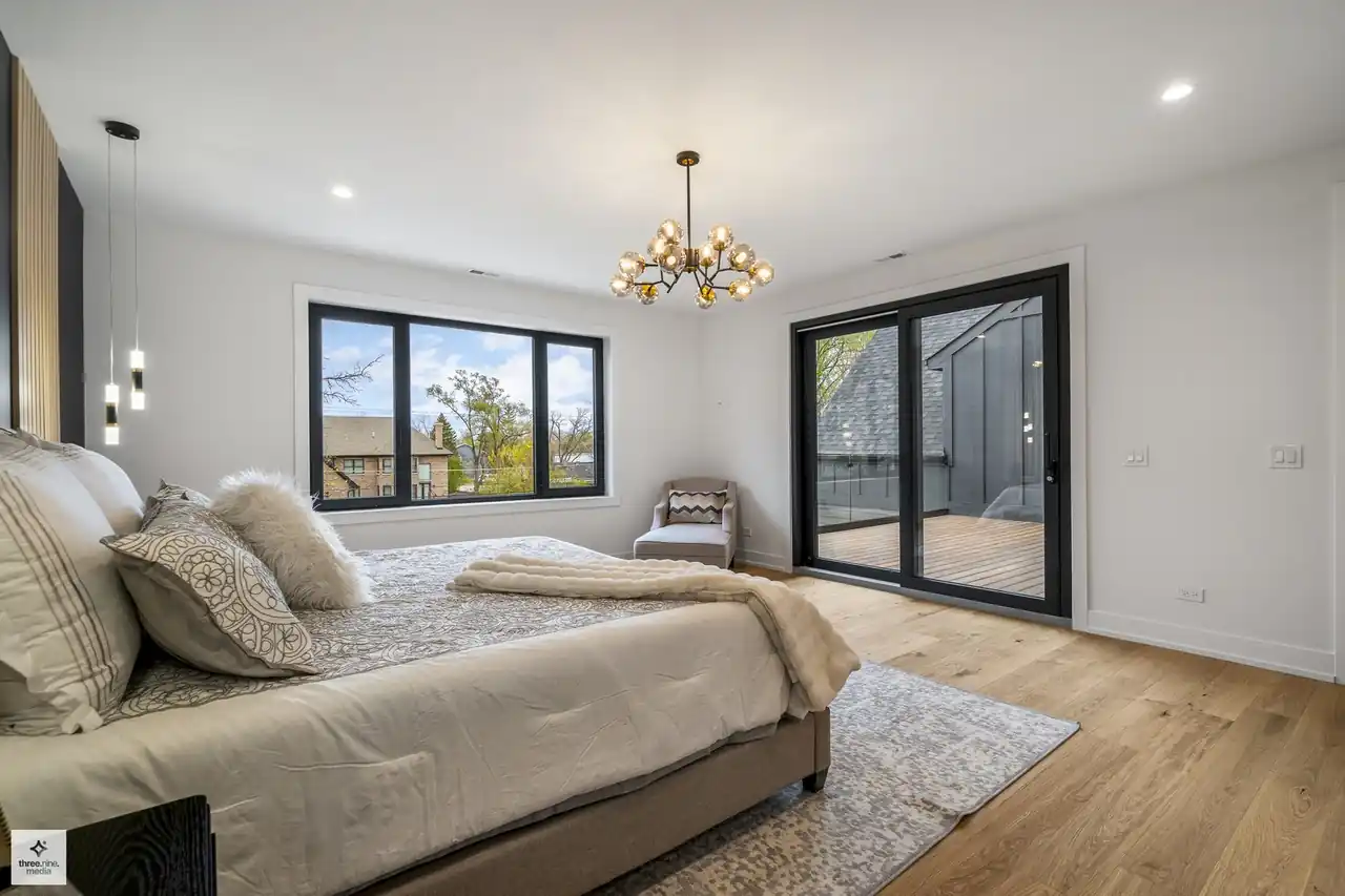 Primary bedroom corner with sliding glass access to a private upper balcony