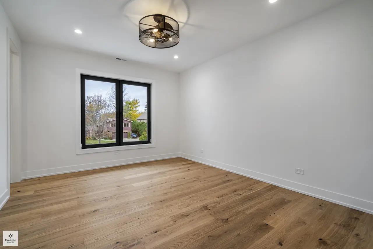 Unfurnished bedroom overlooking a neighboring home in Northbrook, IL