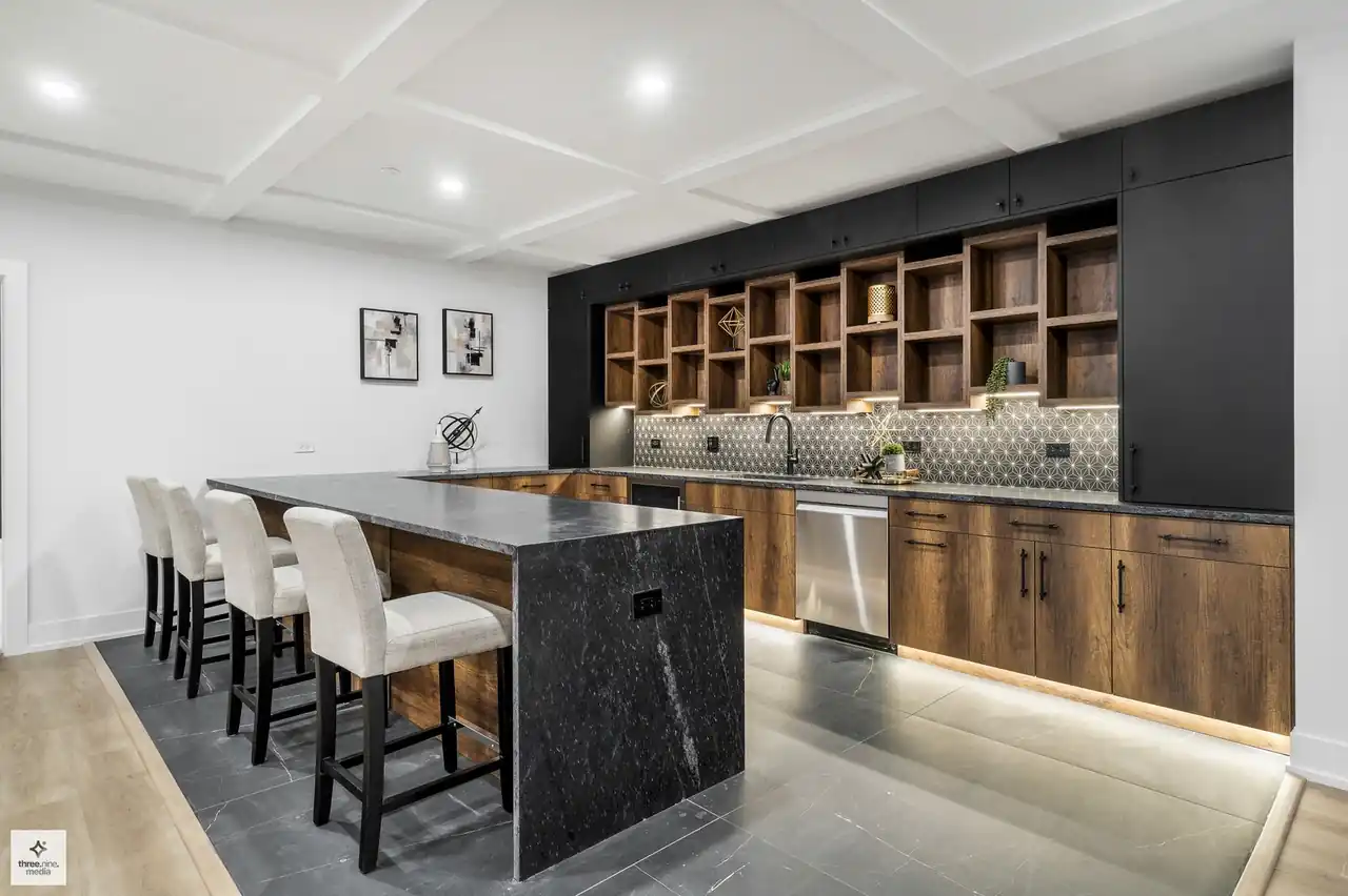 Basement wet bar with matte black cabinetry and patterned tile backsplash