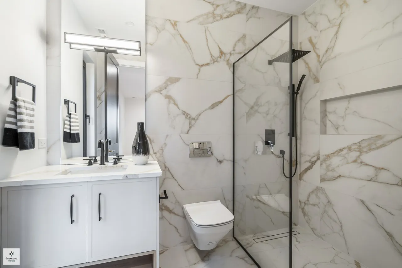Bathroom with a walk-in marble shower and built-in bench seat