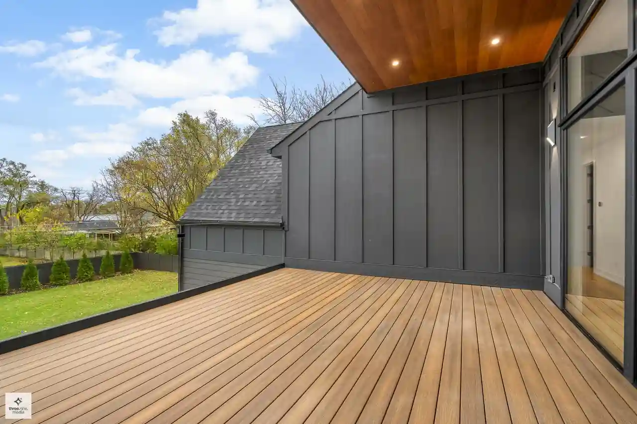Covered upper deck with dark board-and-batten siding and a wood ceiling