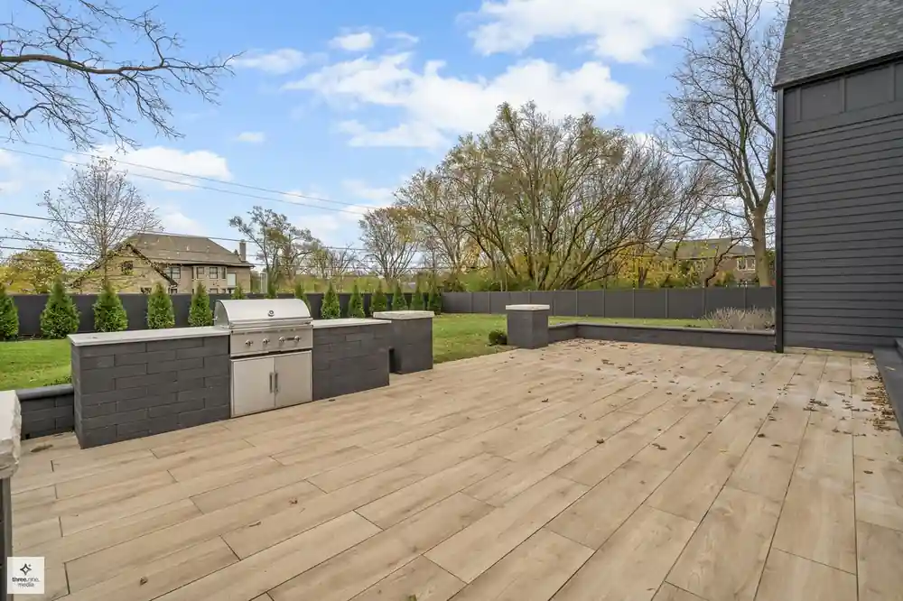 Backyard patio with a built-in grill station along the fenced Northbrook, IL yard