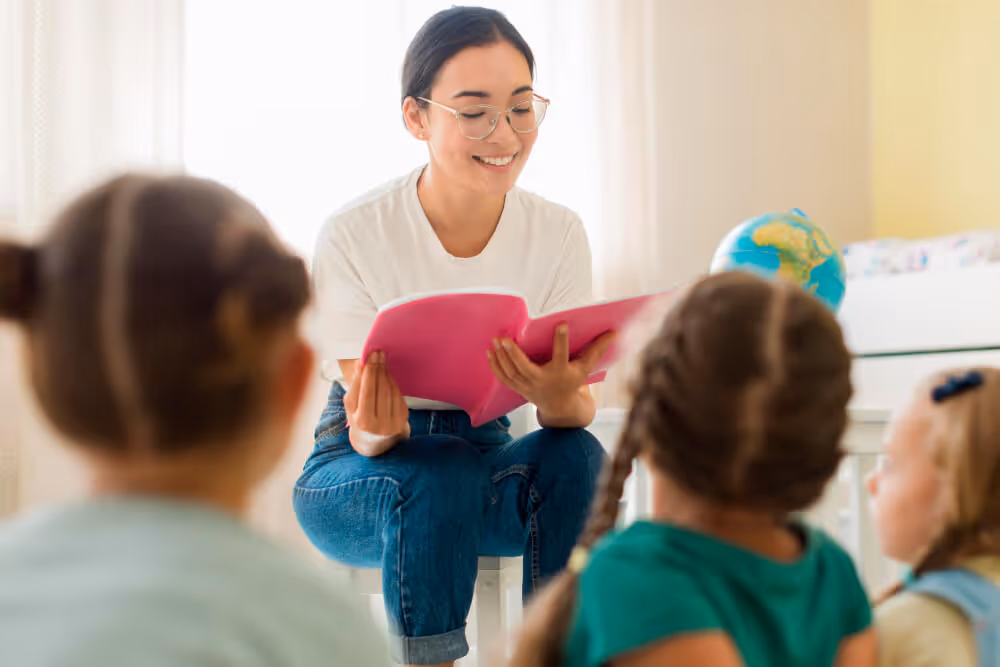 A teacher reading a book for kids
