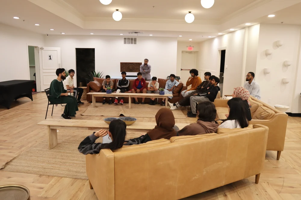 youth and adults attending a presentation in a lounge area