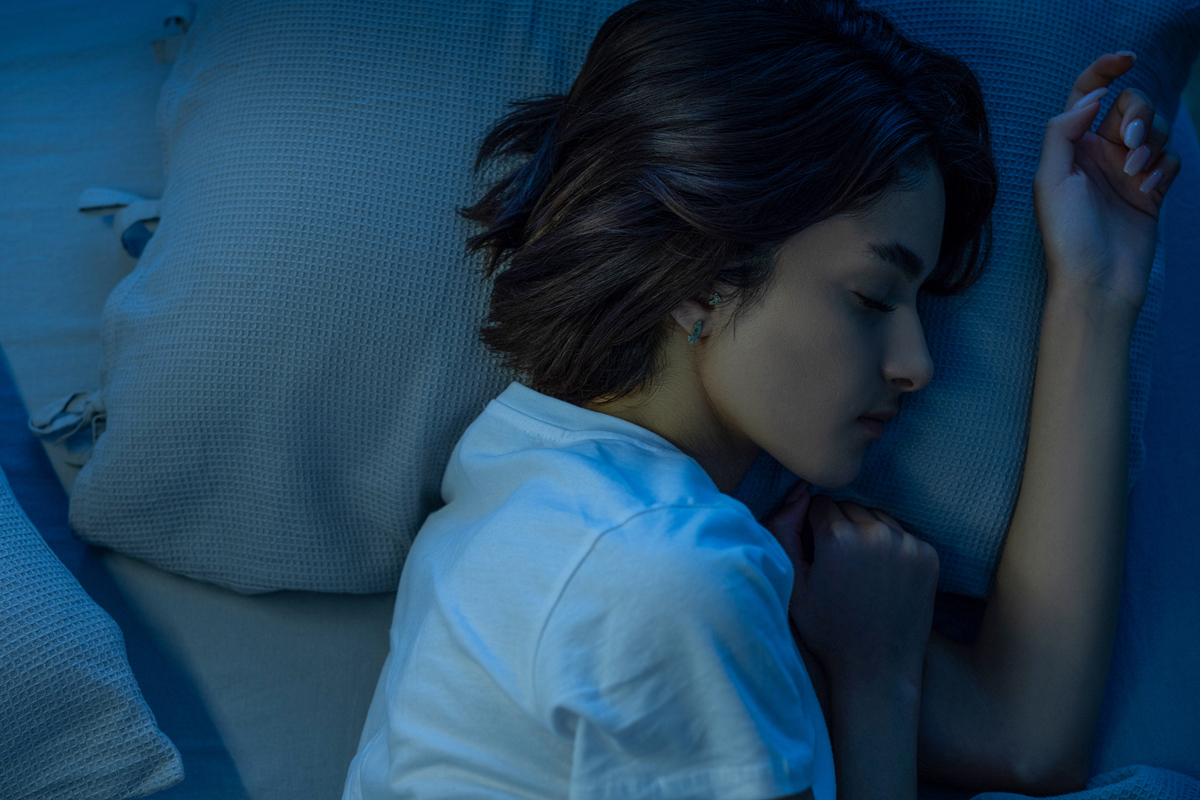 Person sleeping with their head on a pillow