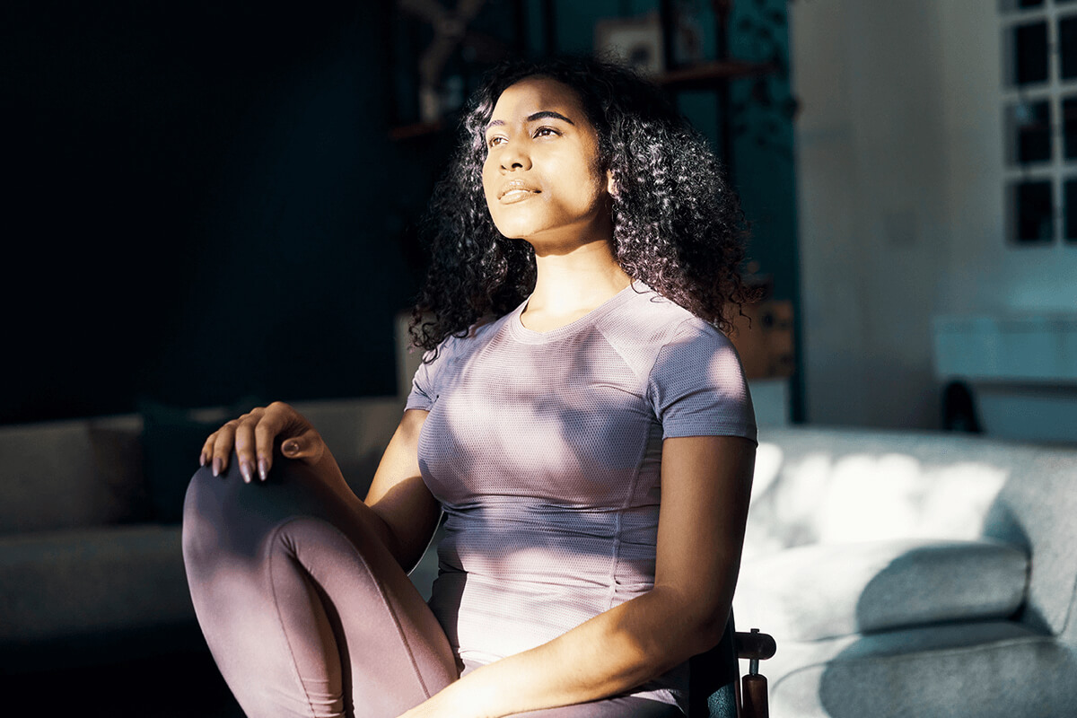 Person sitting indoors with sun on their face