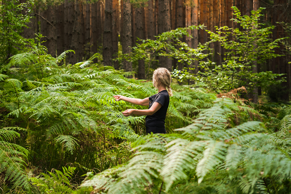 Woman enjoying the calming effects of forest bathing 