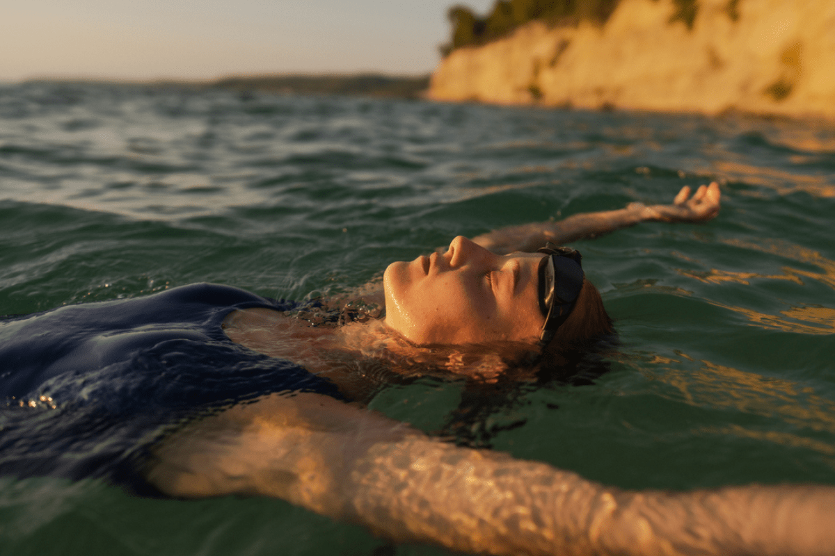 Women laying back relaxing in the ocean after swimming across the bay.