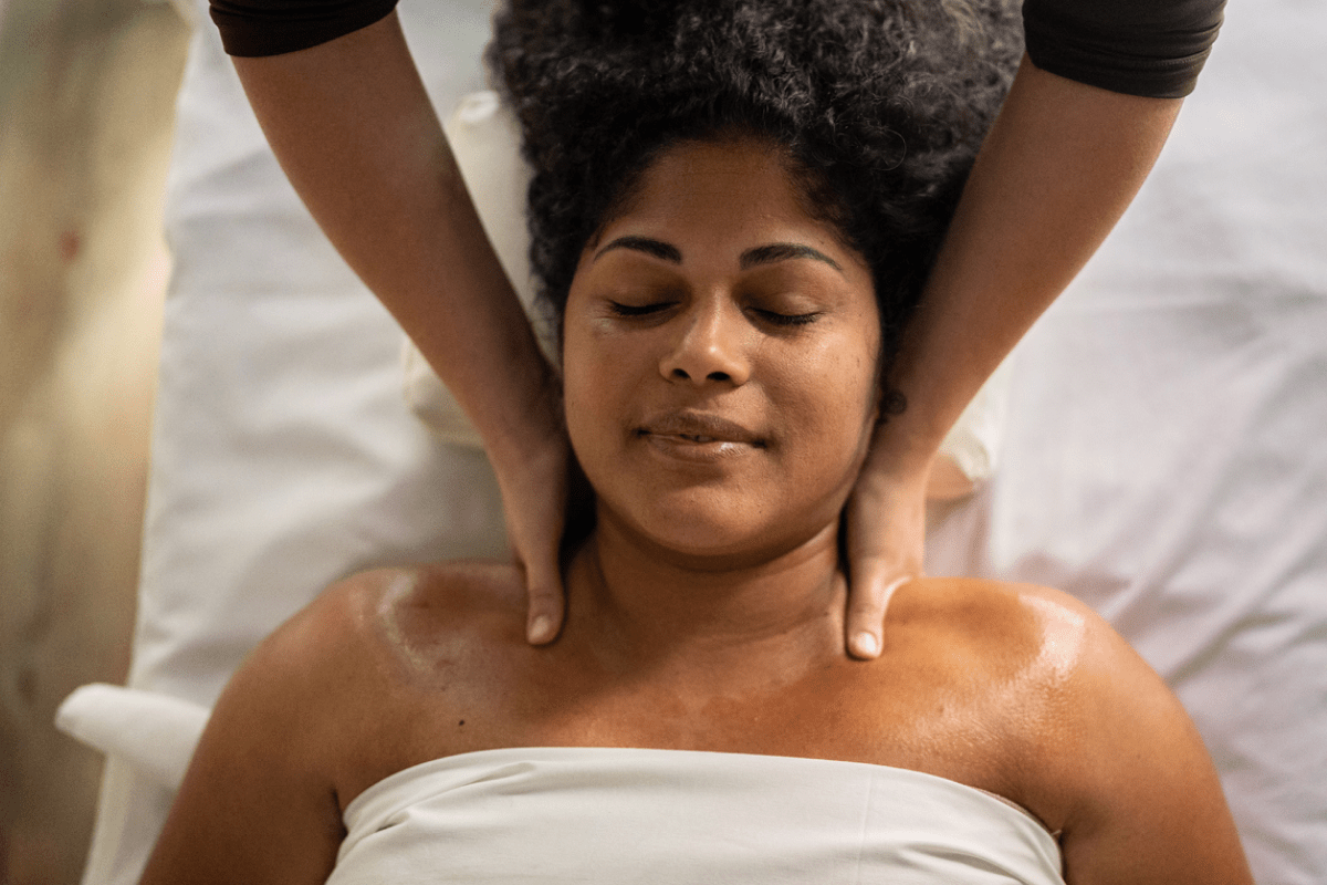 Woman managing her pain with acupressure and reflexology.