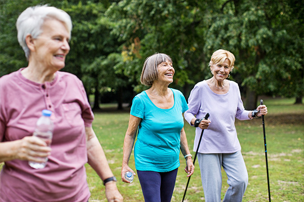 Three senior ladies enjoy exercise outdoors 