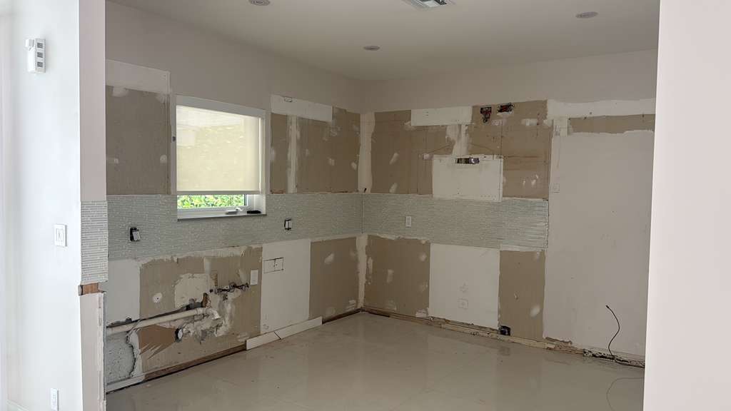 Existing kitchen space before remodeling, stripped to bare walls
