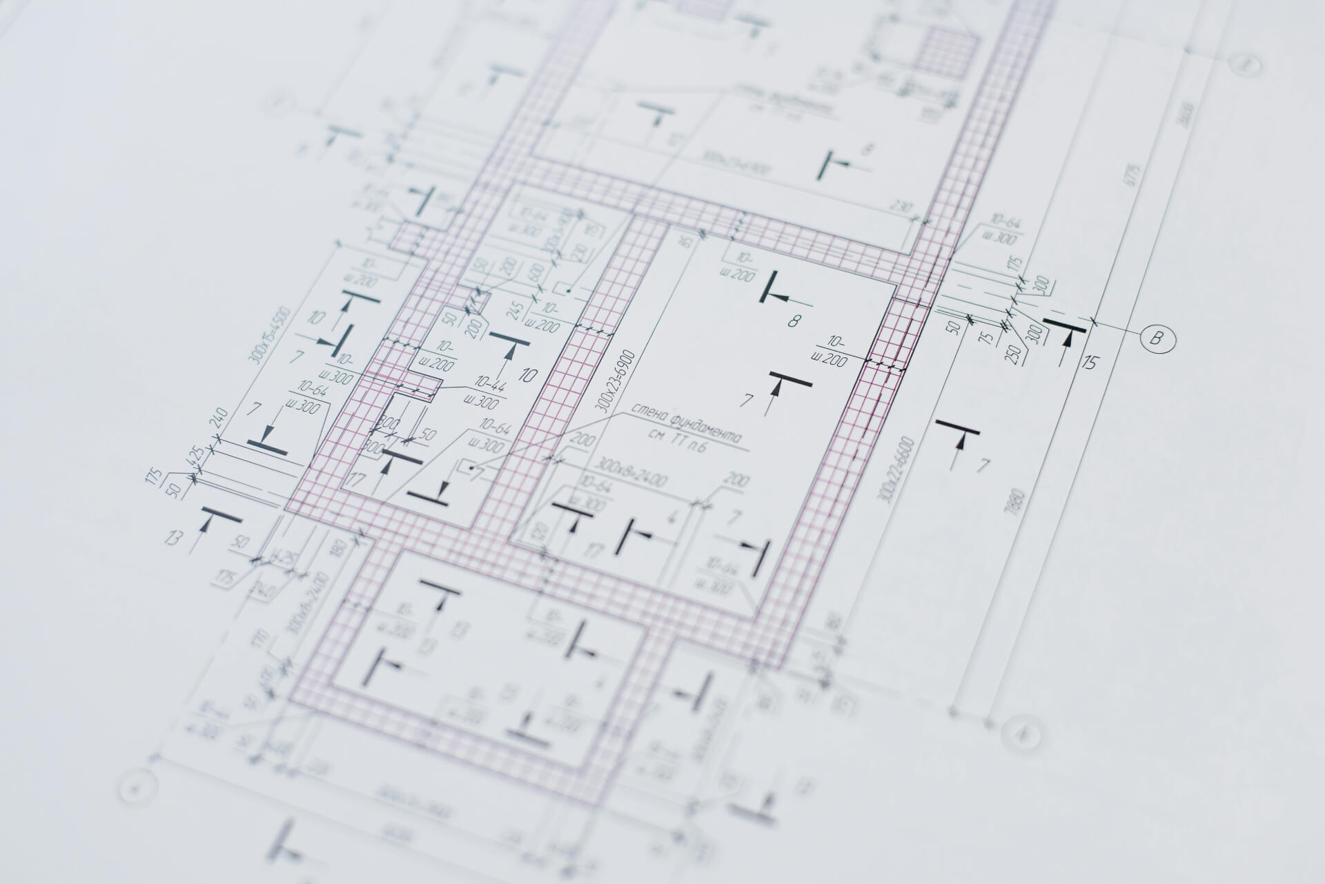 Architectural blueprint with detailed room layouts and measurements on white paper.