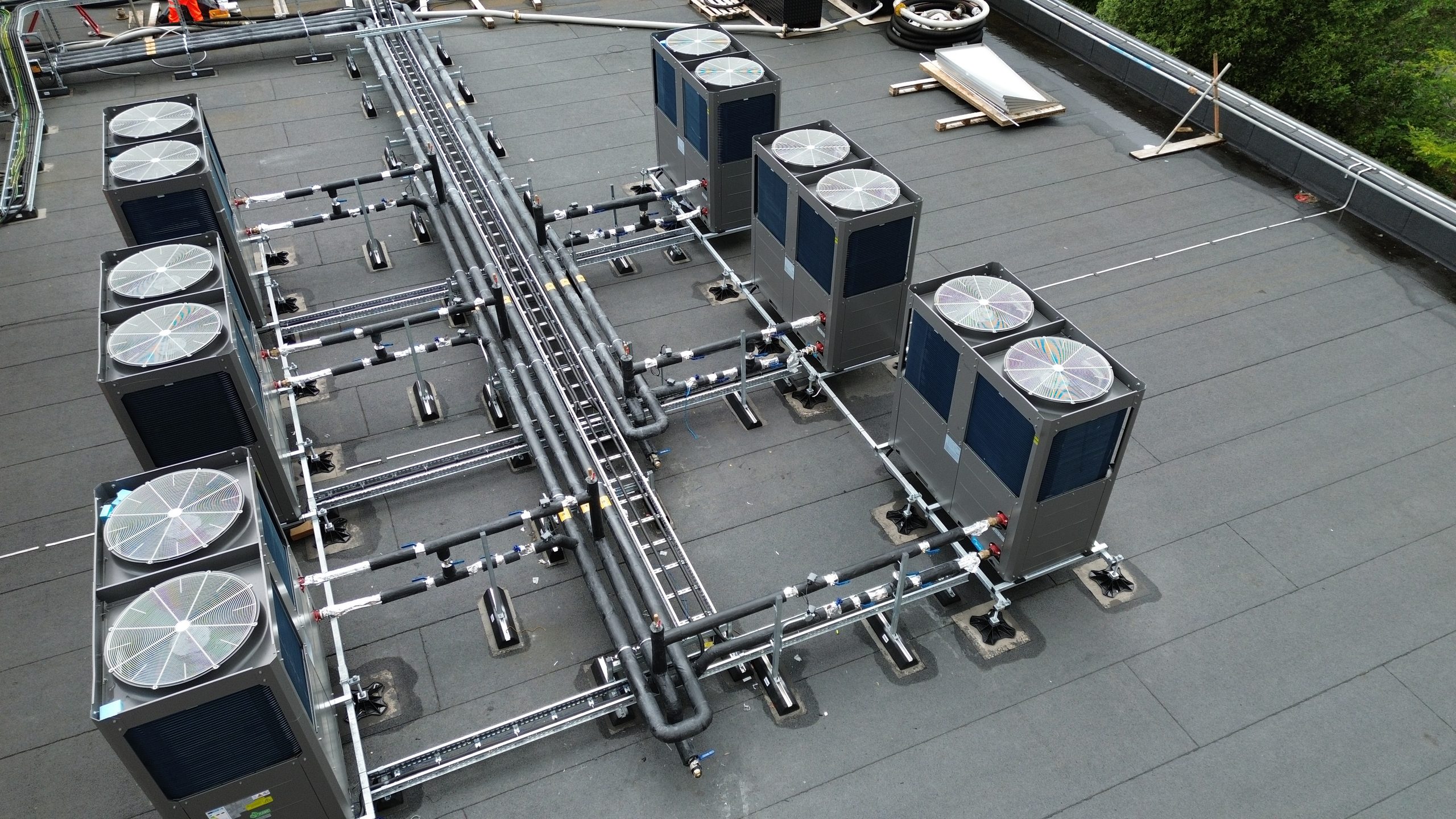 Aerial view of a commercial building with rooftop heat pump plant.