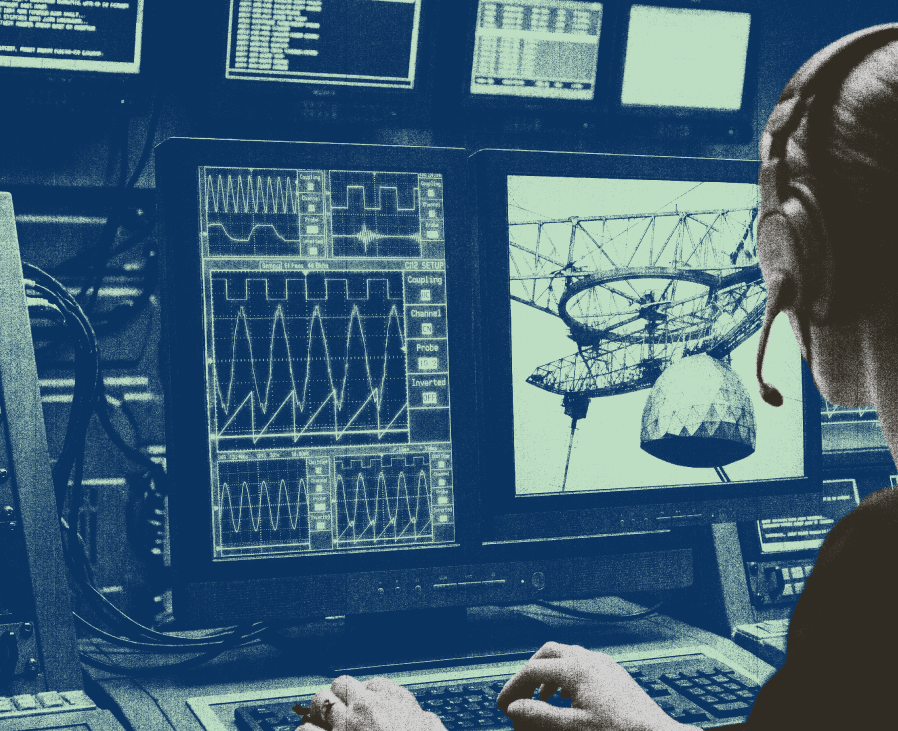 A person in headphones works at a console with monitors showing oscilloscope waveforms and a radio telescope.