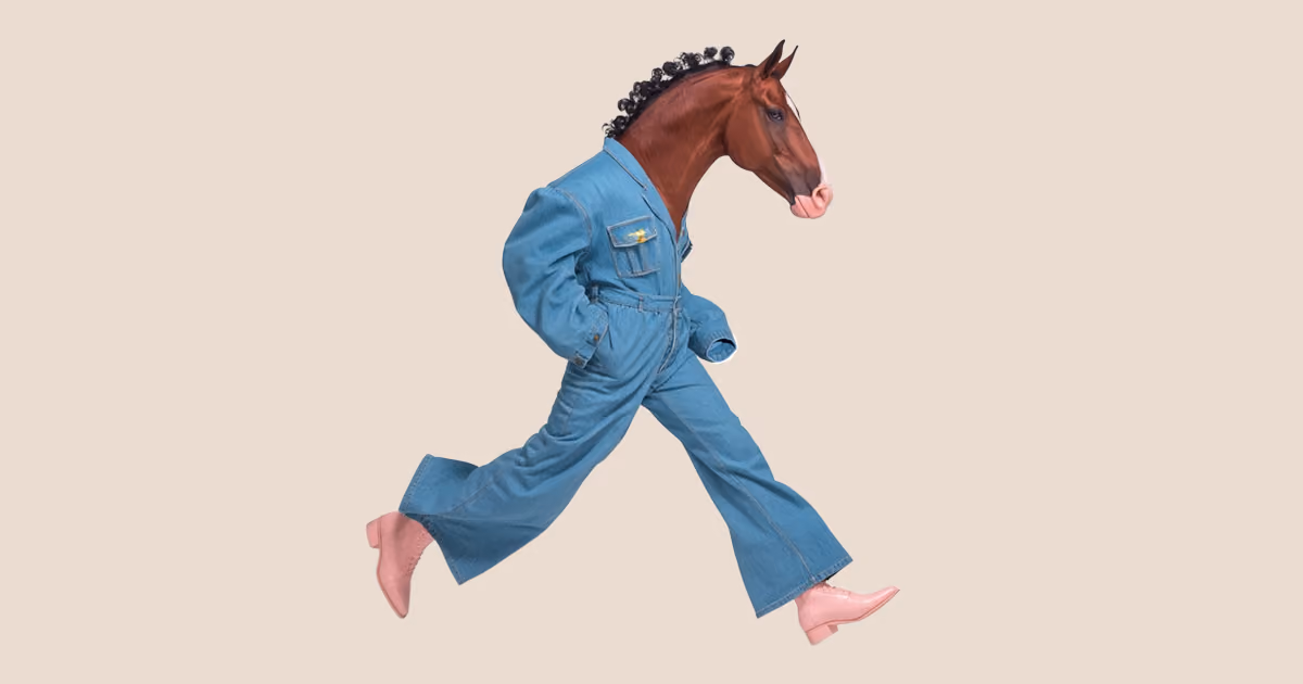 A horse's head on a human body walking mid-stride, wearing a denim jumpsuit and light pink boots.