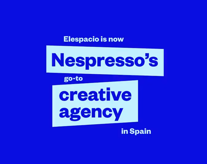 Blue graphic announcing that agency Elespacio is now Nespresso’s go-to creative agency in Spain.