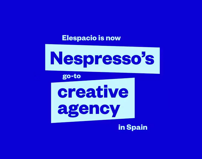 Blue graphic announcing that agency Elespacio is now Nespresso’s go-to creative agency in Spain.