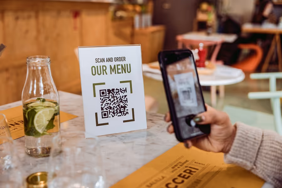 Friends in a restaurant scanning Online Food and Drinks menu
