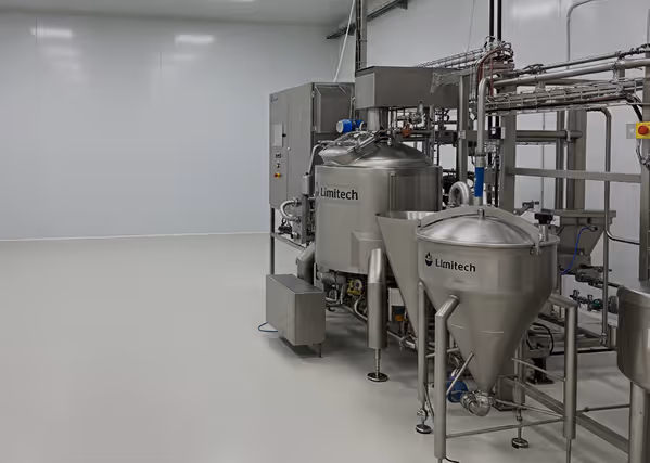 Industrial stainless steel Limitech tanks and equipment inside a clean processing facility.