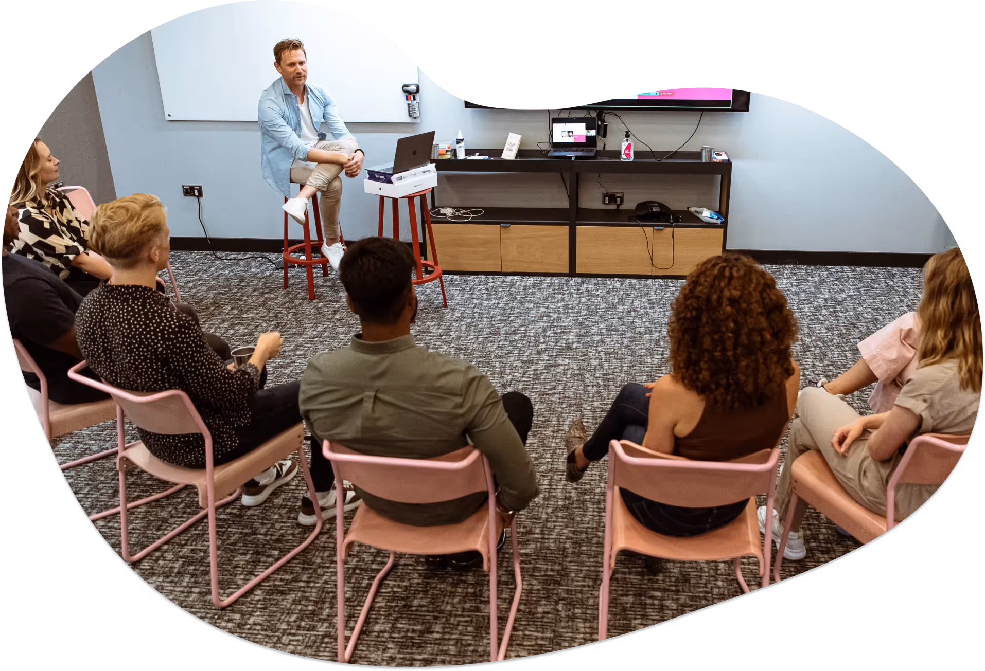 Tom Lavery coaching a group of salespeople sat in a circle in 2021