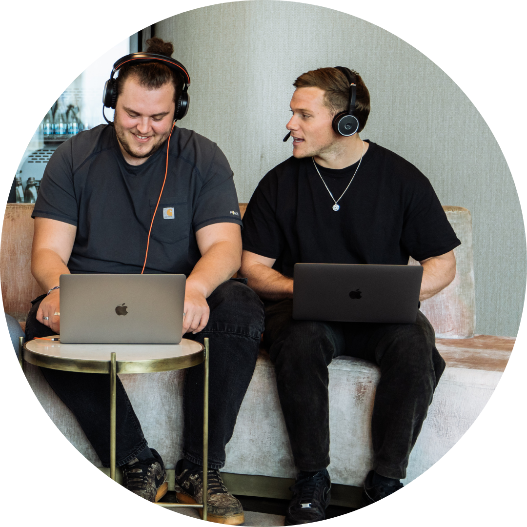 Two young Jiminny employees smiling while working