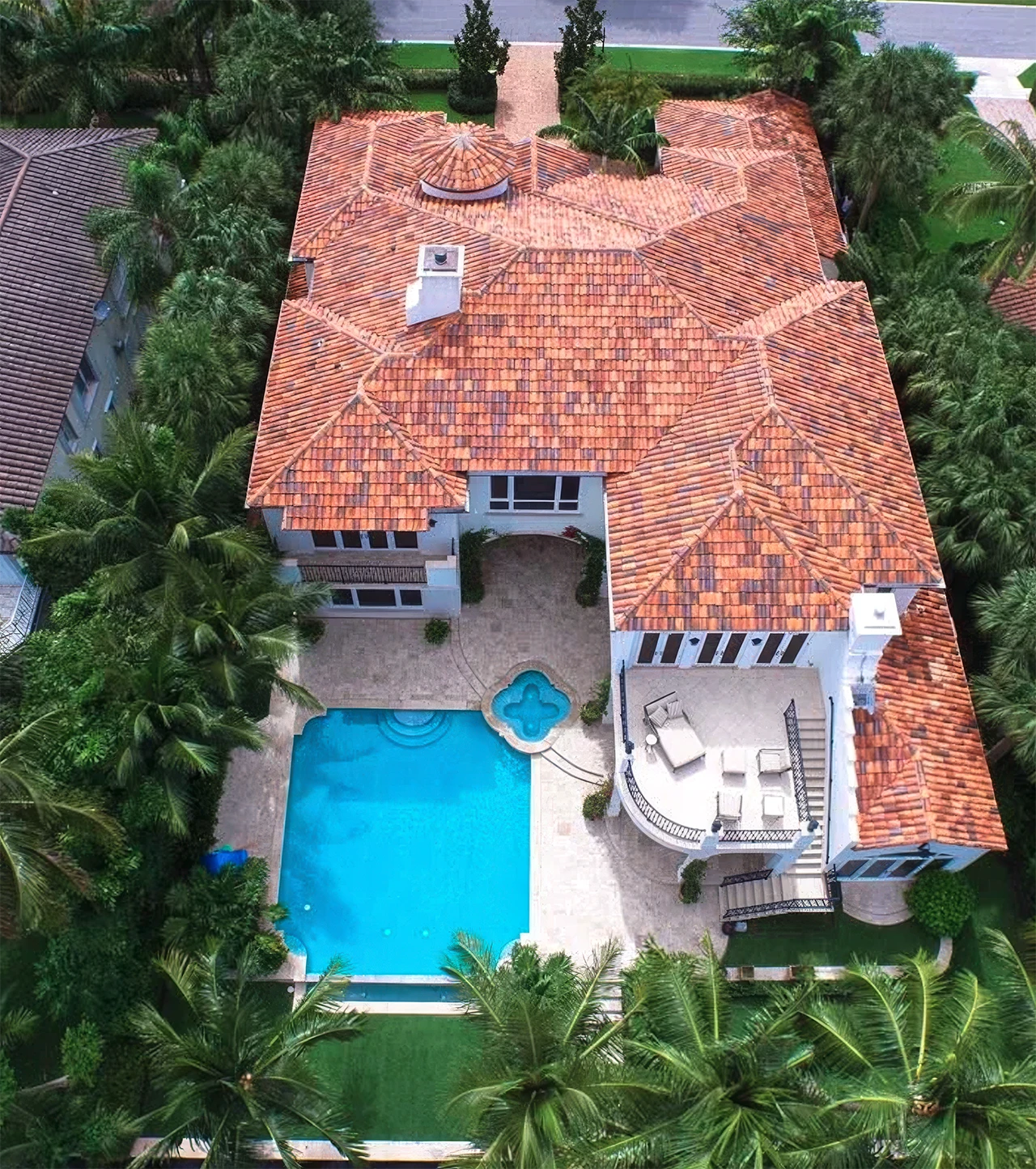 Aerial view of a private residence with a pool, spa and palm-lined grounds